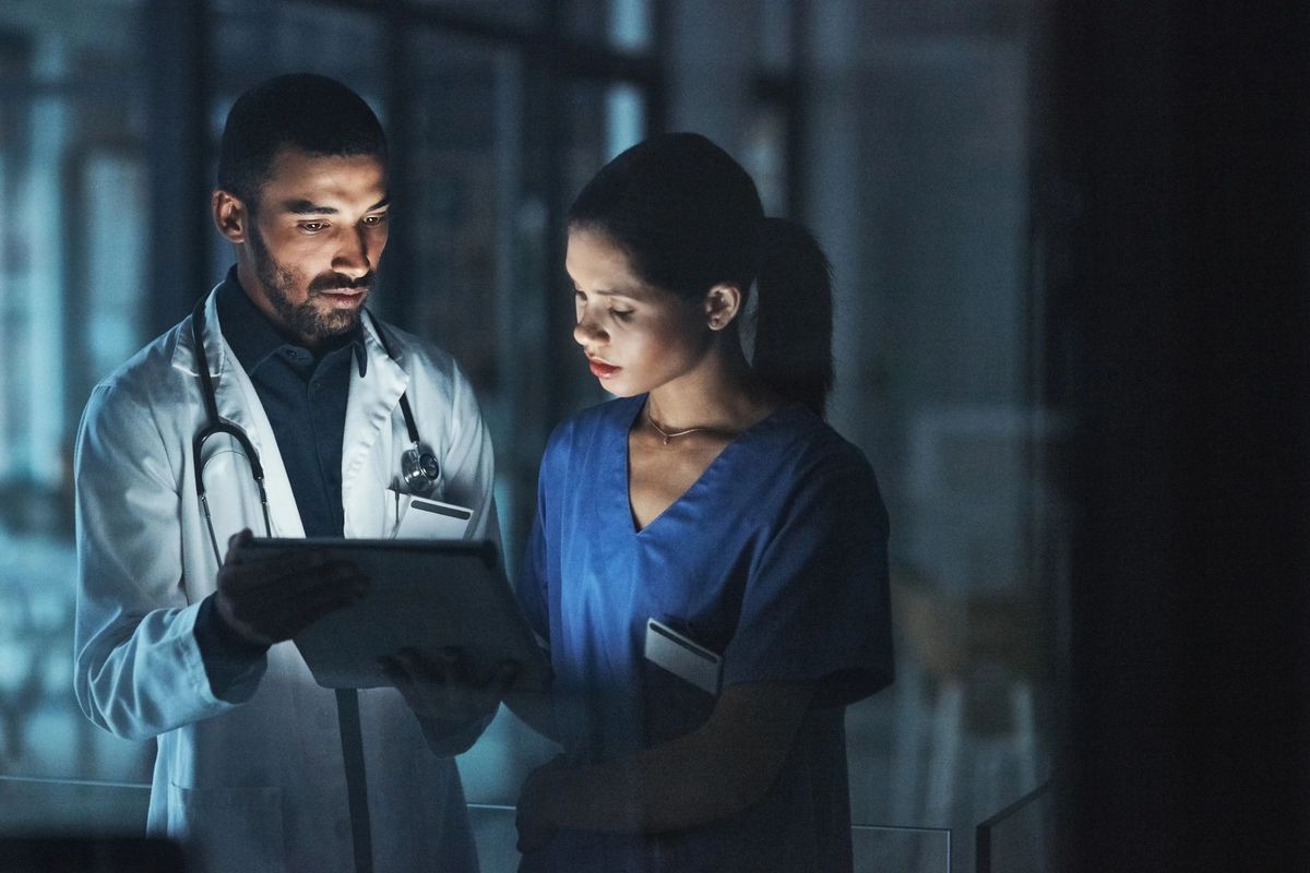 Doctor and nurse with glowing tablet