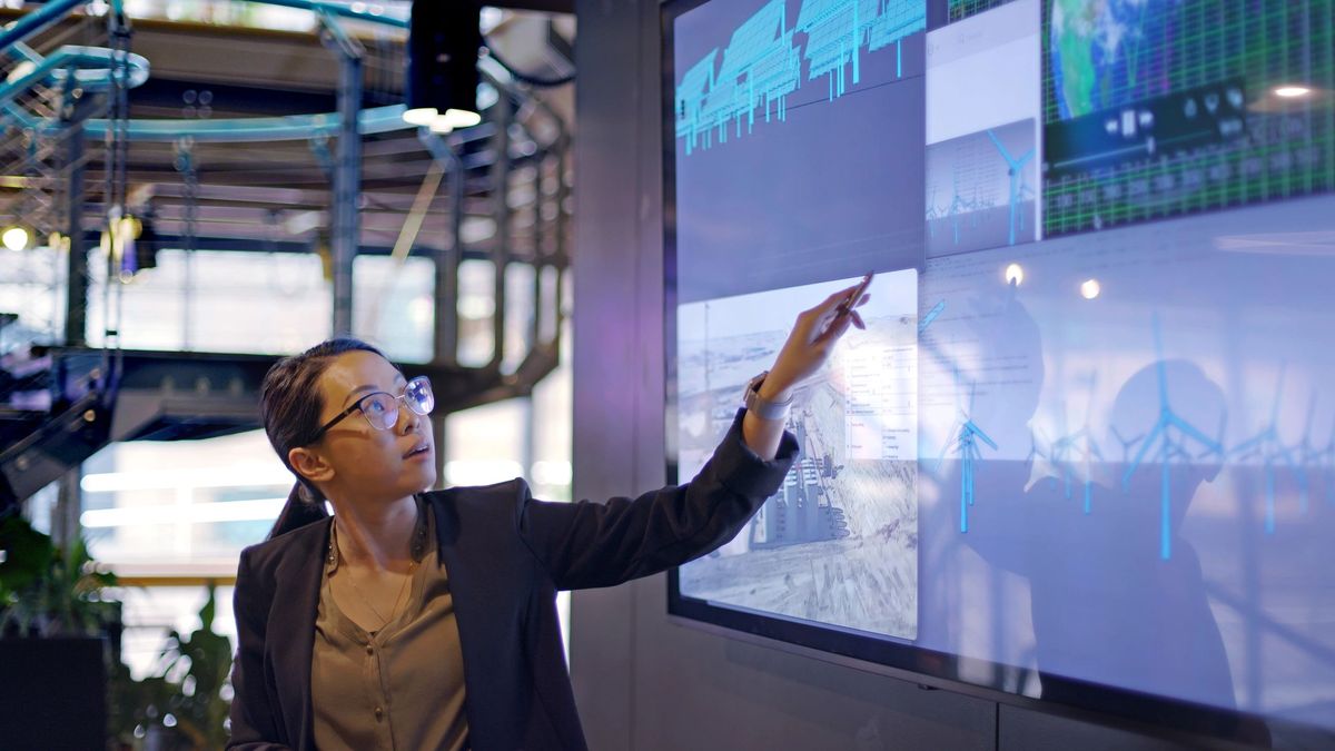 Analyst working with a large interactive data wall