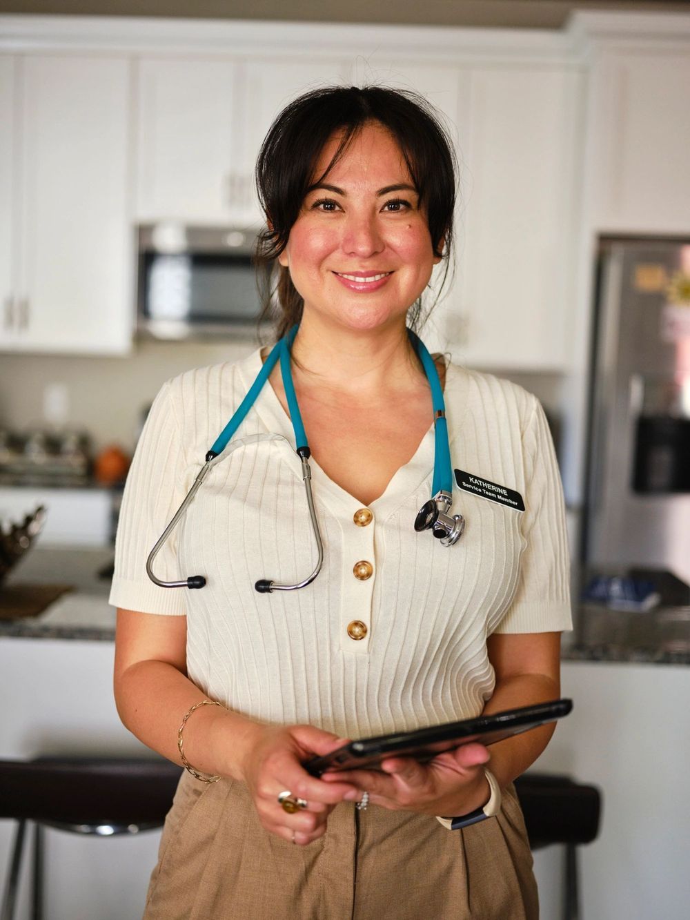 Smiling nurse with stethoscope and tablet